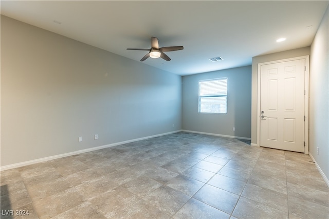 empty room featuring ceiling fan and light tile patterned floors