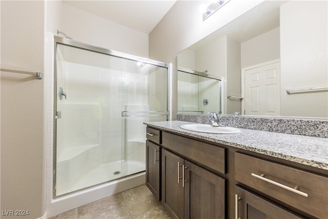 bathroom featuring vanity and an enclosed shower