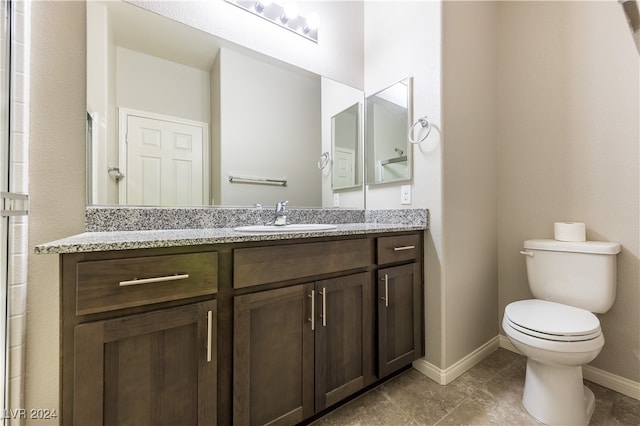 bathroom featuring vanity, toilet, and tile patterned flooring