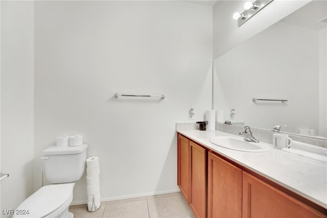 bathroom with vanity, toilet, and tile patterned flooring