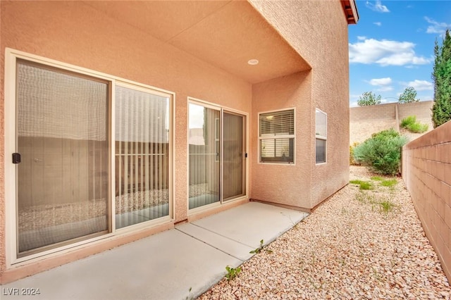 8212 Minots Ledge Ave, Las Vegas, NV 89147 - view of exterior entry featuring stucco siding and a patio area