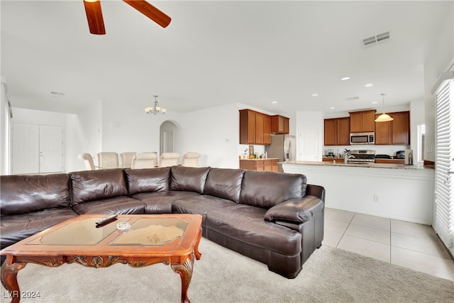 living room with sink, ceiling fan, and light tile patterned floors