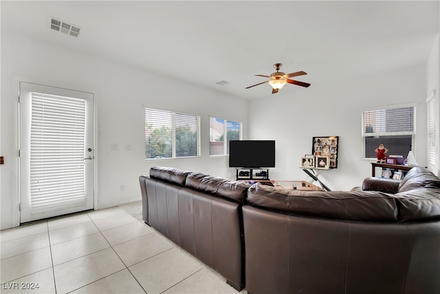 tiled living room featuring ceiling fan