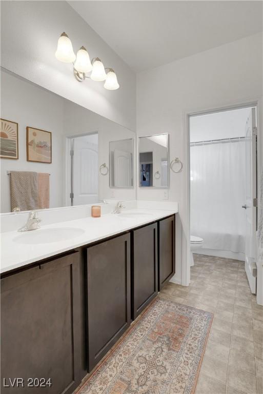 full bathroom featuring vanity, shower / tub combo, and toilet