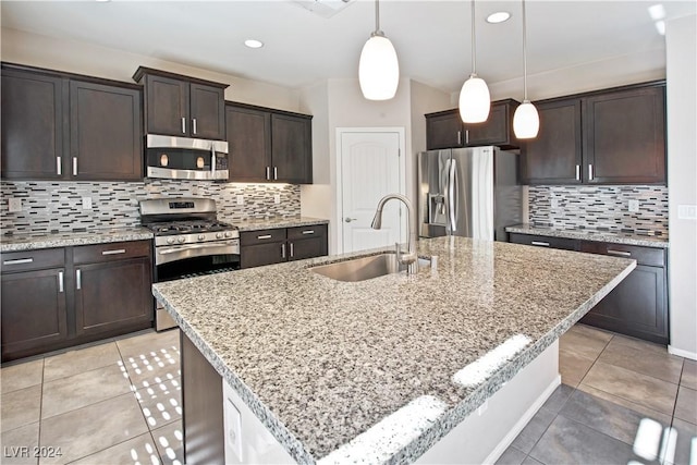 kitchen with stainless steel appliances and an island with sink