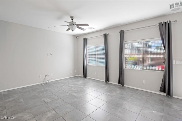 spare room featuring tile patterned flooring and ceiling fan