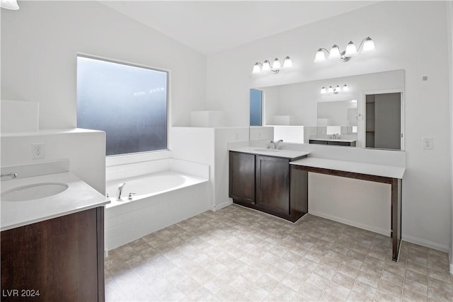 bathroom with vanity, tiled bath, and lofted ceiling