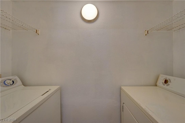 laundry room with washing machine and clothes dryer and laundry area