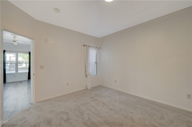 unfurnished room featuring light colored carpet