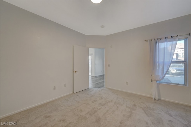 empty room featuring light colored carpet