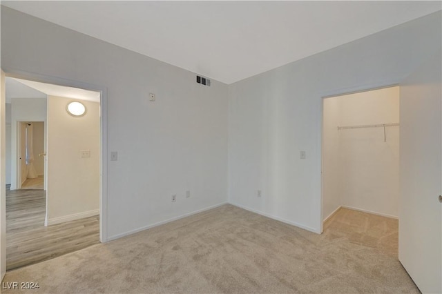 unfurnished room featuring baseboards, visible vents, and carpet flooring