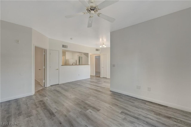 unfurnished living room featuring baseboards, visible vents, wood finished floors, and a ceiling fan