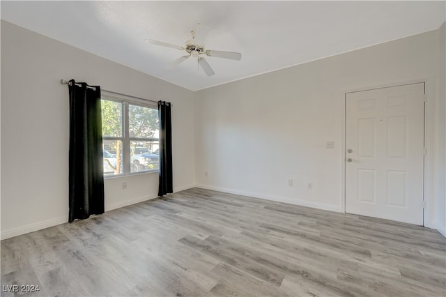 empty room featuring light hardwood / wood-style flooring and ceiling fan