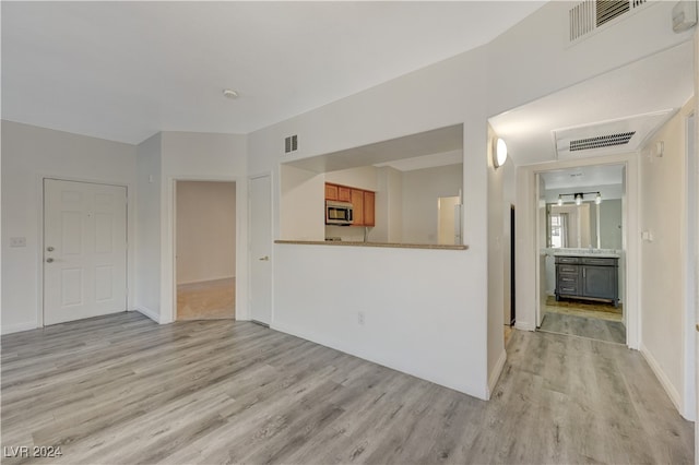 unfurnished living room with light hardwood / wood-style floors