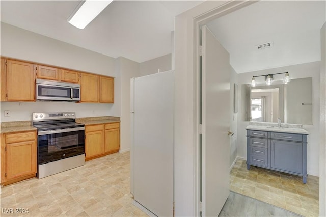 kitchen with light countertops, a sink, appliances with stainless steel finishes, and visible vents