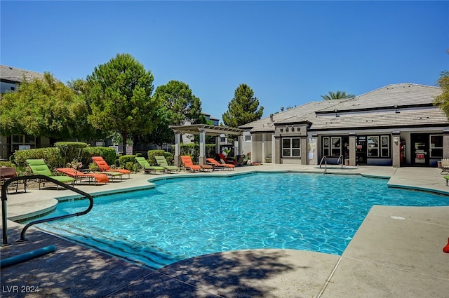 view of pool with a pergola and a patio area