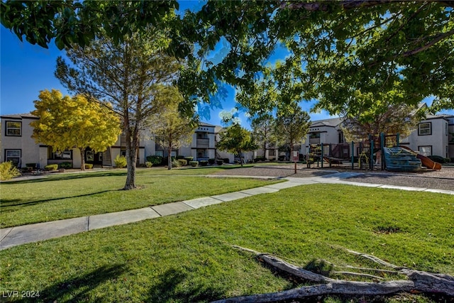 surrounding community with a yard and a playground