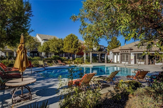 view of pool with a pergola and a patio area