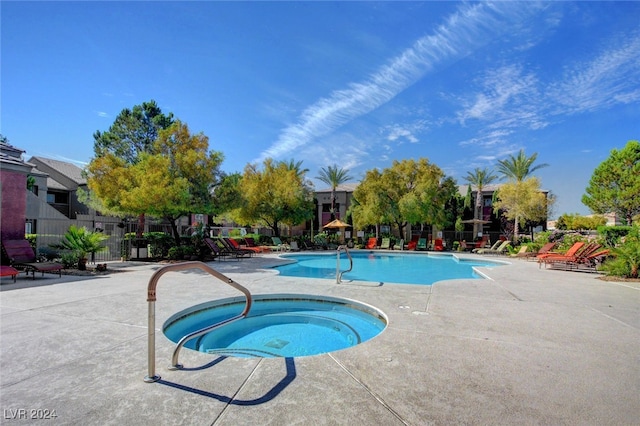 view of pool featuring a community hot tub and a patio