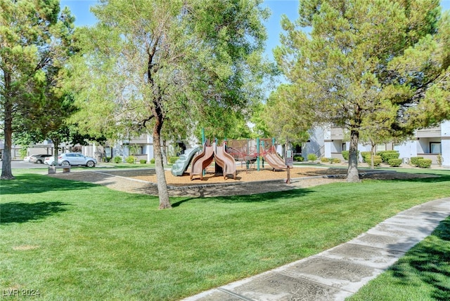 surrounding community featuring a playground and a lawn