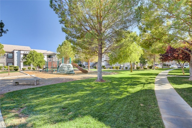 view of property's community featuring a yard and a playground