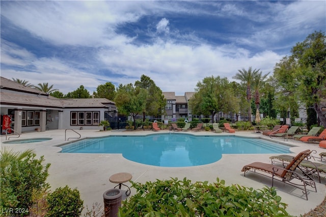 view of pool featuring a patio and a community hot tub