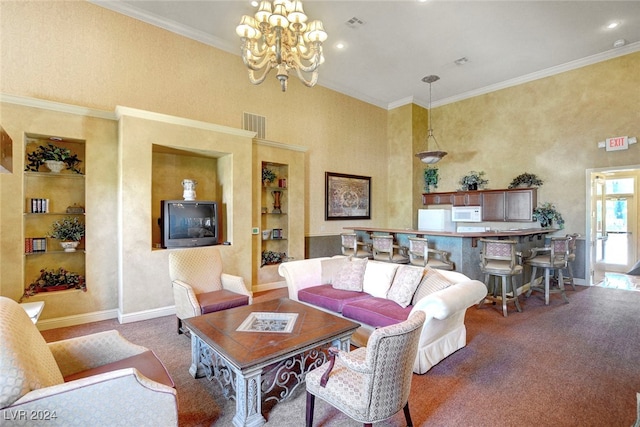 carpeted living room with a notable chandelier, crown molding, a high ceiling, and built in features