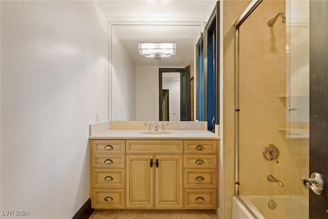 bathroom with vanity and bath / shower combo with glass door