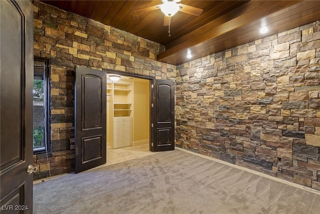 carpeted empty room with ceiling fan and wooden ceiling