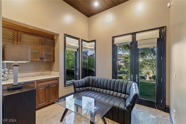 interior space with sink, wooden ceiling, and lofted ceiling