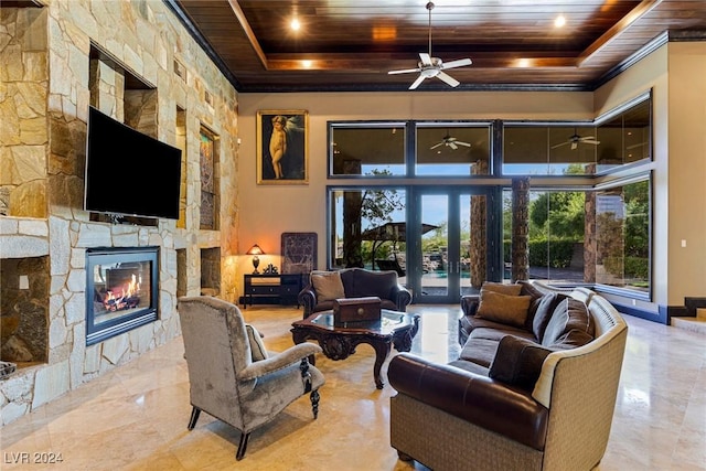 living room featuring a fireplace, french doors, a tray ceiling, and wood ceiling