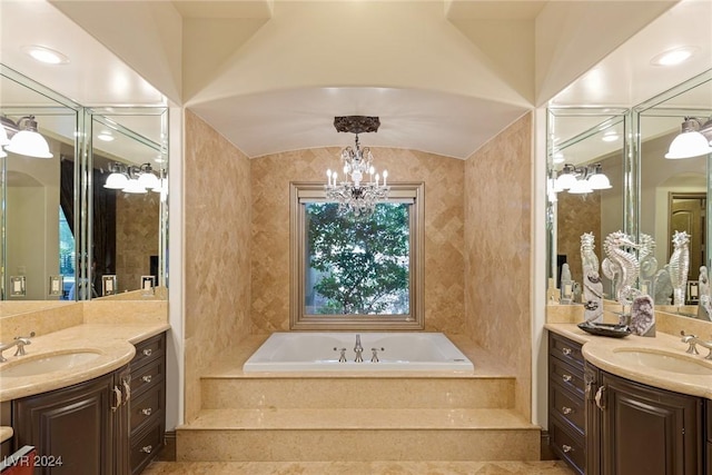 bathroom with vanity, tiled bath, vaulted ceiling, and a notable chandelier