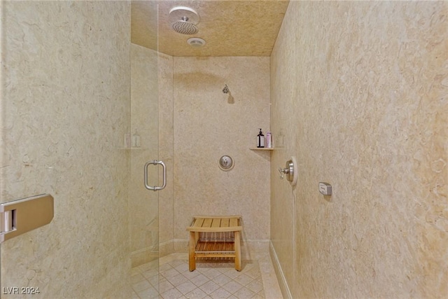 bathroom with tile patterned flooring and an enclosed shower