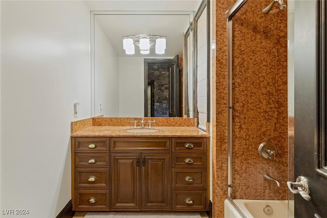 bathroom with shower / bath combination with glass door and vanity