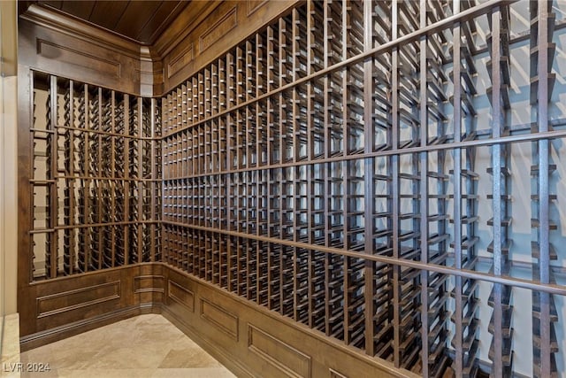 wine room featuring wood walls and wooden ceiling