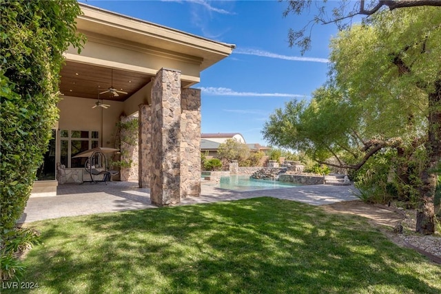 view of yard with pool water feature, ceiling fan, and a patio