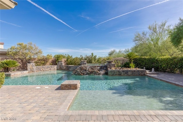 view of pool with pool water feature and a patio area