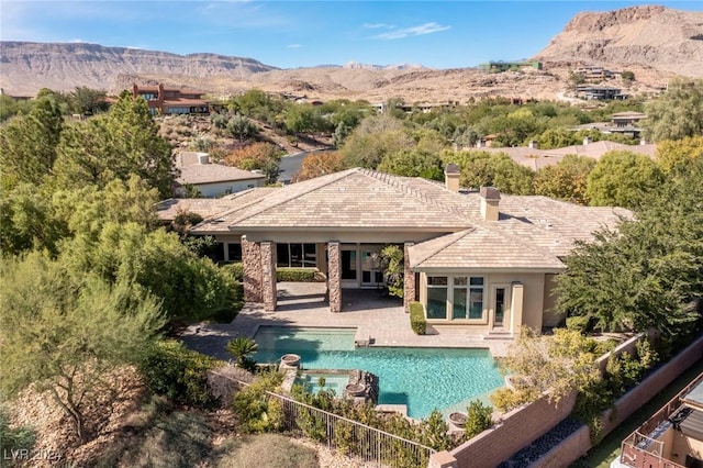 exterior space with a mountain view, a fenced in pool, and a patio area