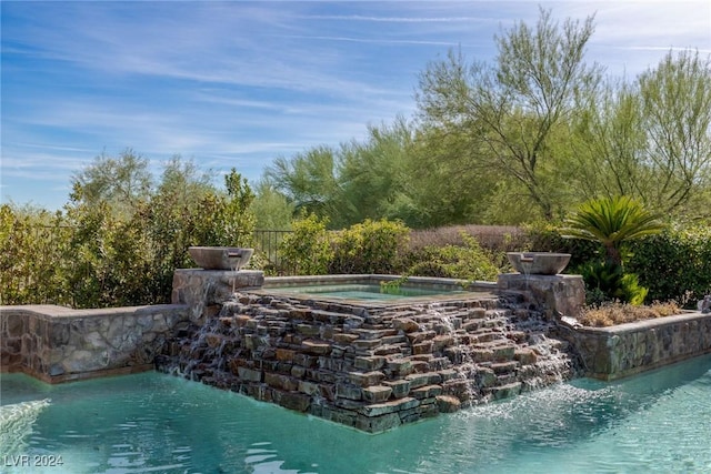 view of pool with pool water feature