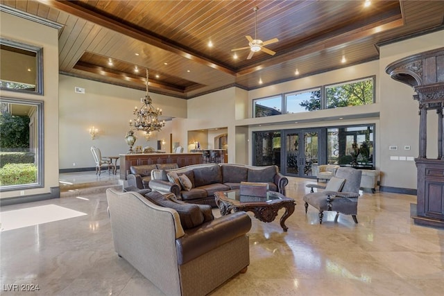 living room with french doors, a raised ceiling, a towering ceiling, wood ceiling, and ceiling fan with notable chandelier