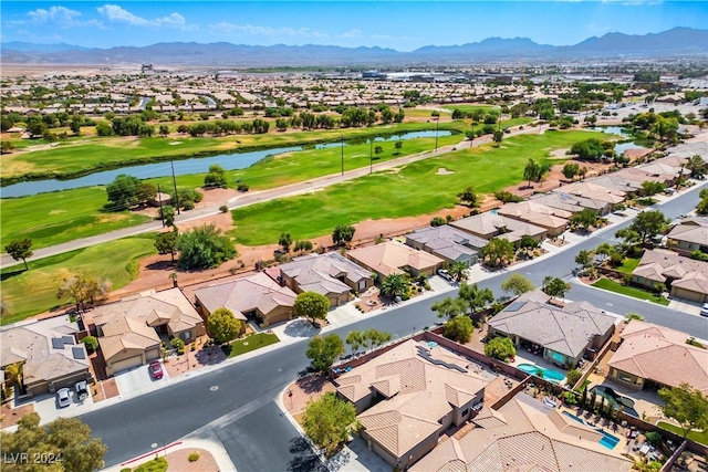 aerial view featuring a residential view, view of golf course, and a water and mountain view