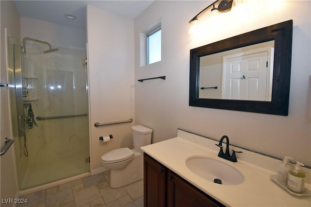 bathroom featuring a stall shower, vanity, and toilet