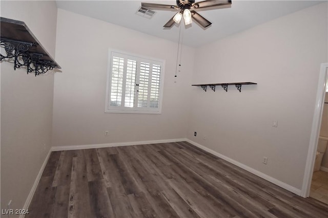 empty room with visible vents, baseboards, and wood finished floors