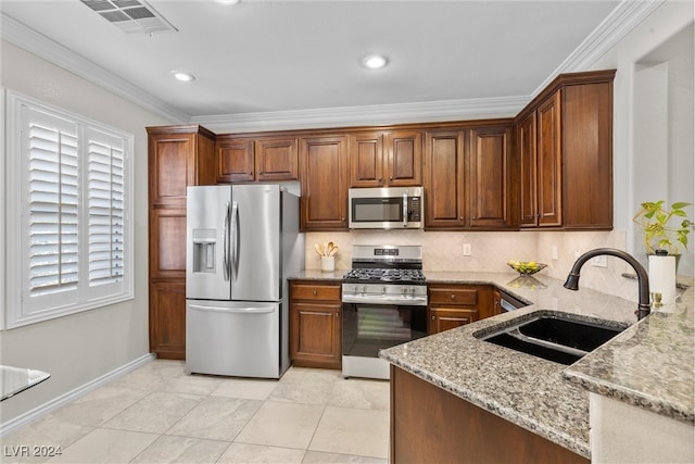 kitchen featuring decorative backsplash, light stone countertops, sink, crown molding, and stainless steel appliances