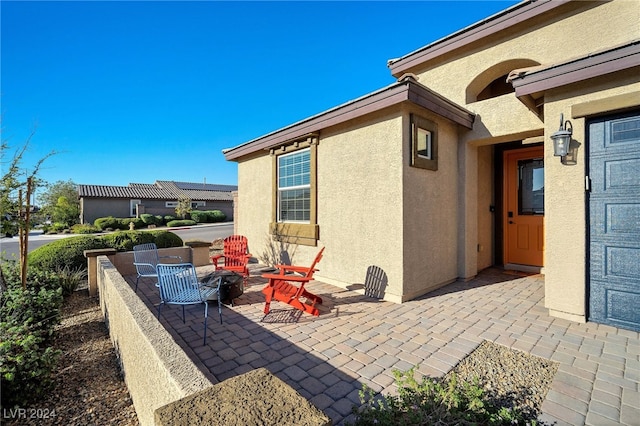 view of patio / terrace featuring an outdoor fire pit