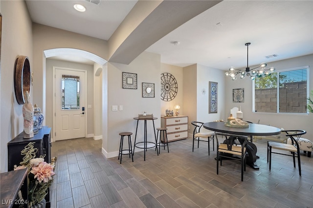 dining space featuring a chandelier and dark hardwood / wood-style floors