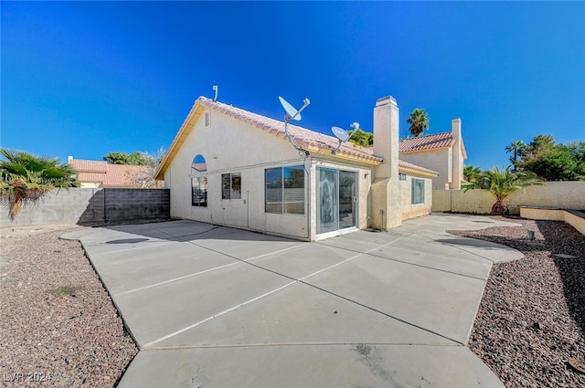 rear view of property featuring a patio