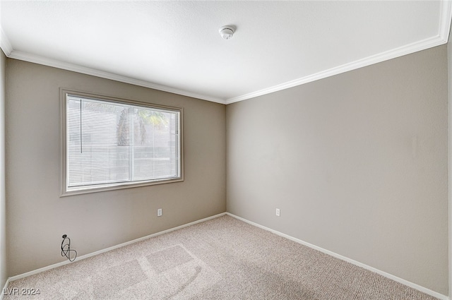 empty room featuring light carpet and crown molding