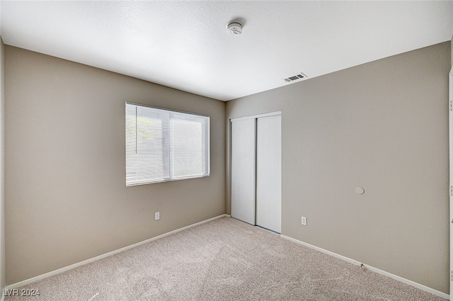 unfurnished bedroom featuring a closet and carpet floors