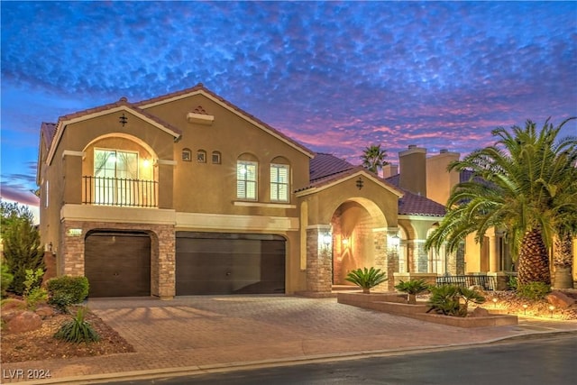 mediterranean / spanish home featuring a garage